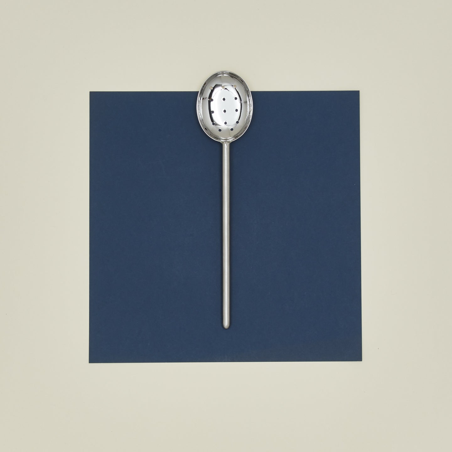 Simple metal slotted spoon in silver