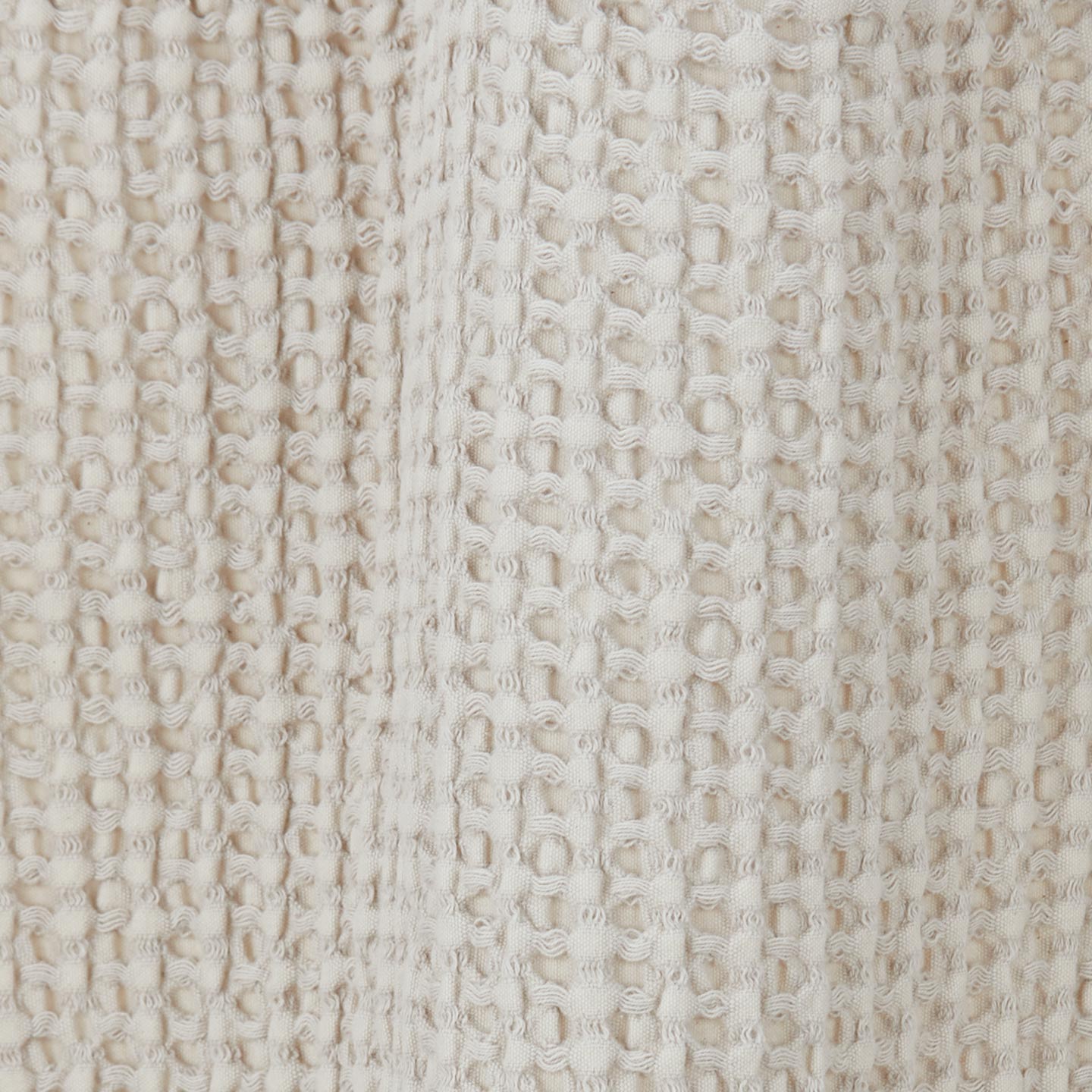 Close up view of simple waffle shower curtain in light grey