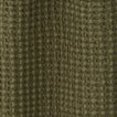 Close up view of simple waffle shower curtain in olive
