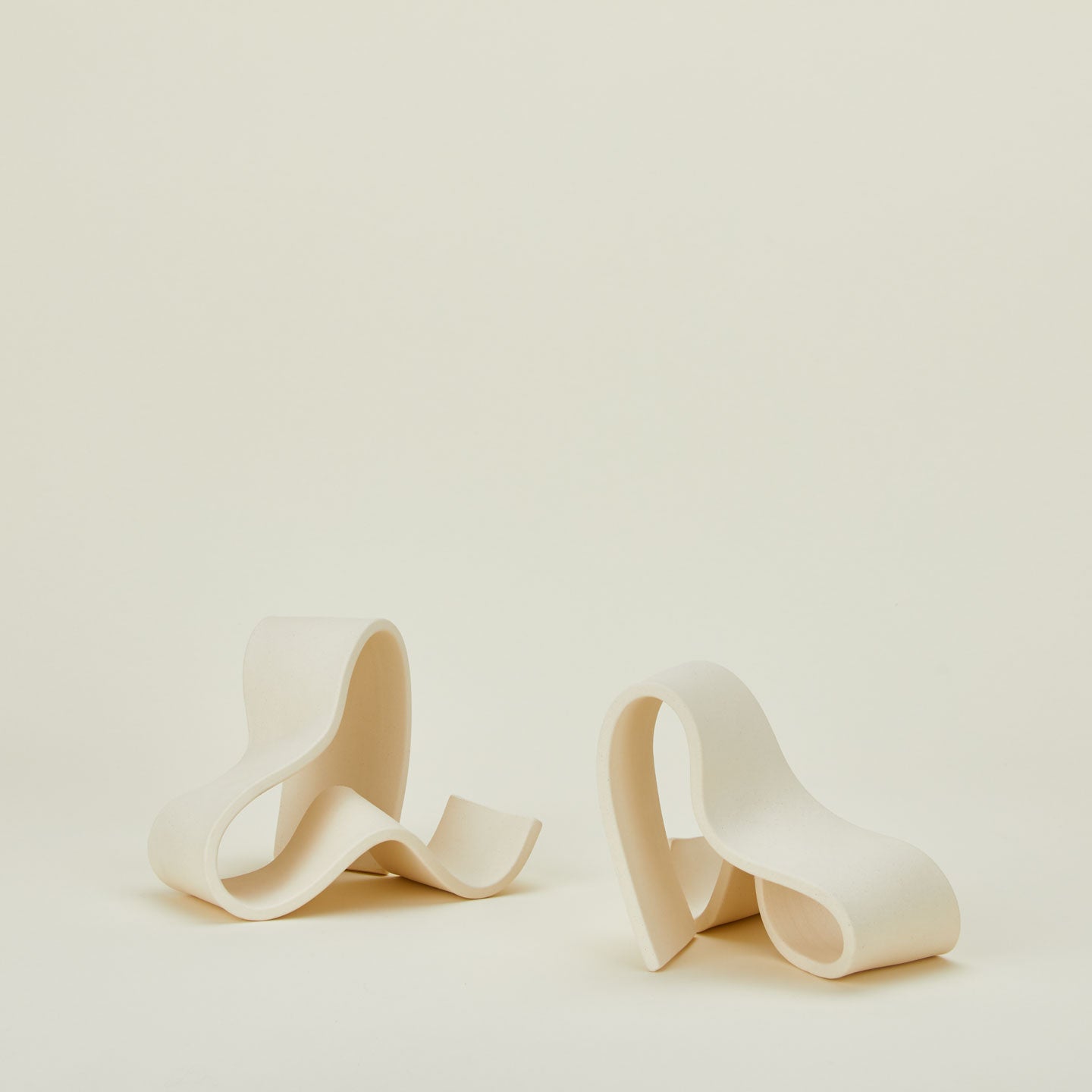 Organically shaped neutral stoneware bookends.