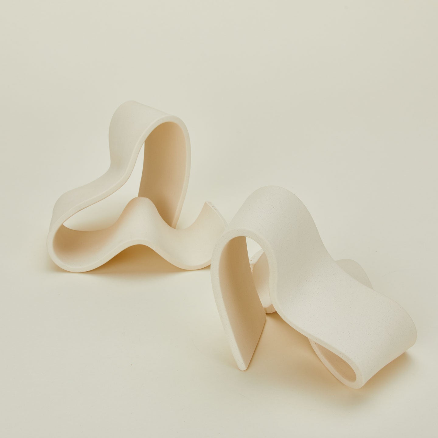 Close up of organically shaped neutral stoneware bookends.
