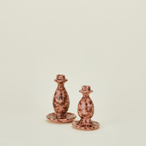 Large and small candlestick holders in blush and terracotta