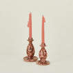 Large and small candlestick holders in blush and terracotta with candles