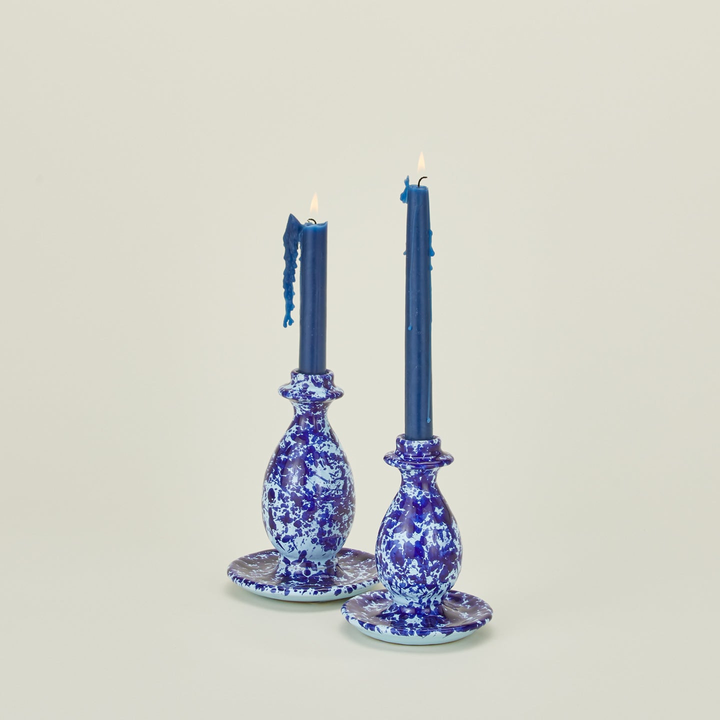 Large and small splatter candle stick holders in sky and cobalt with candles