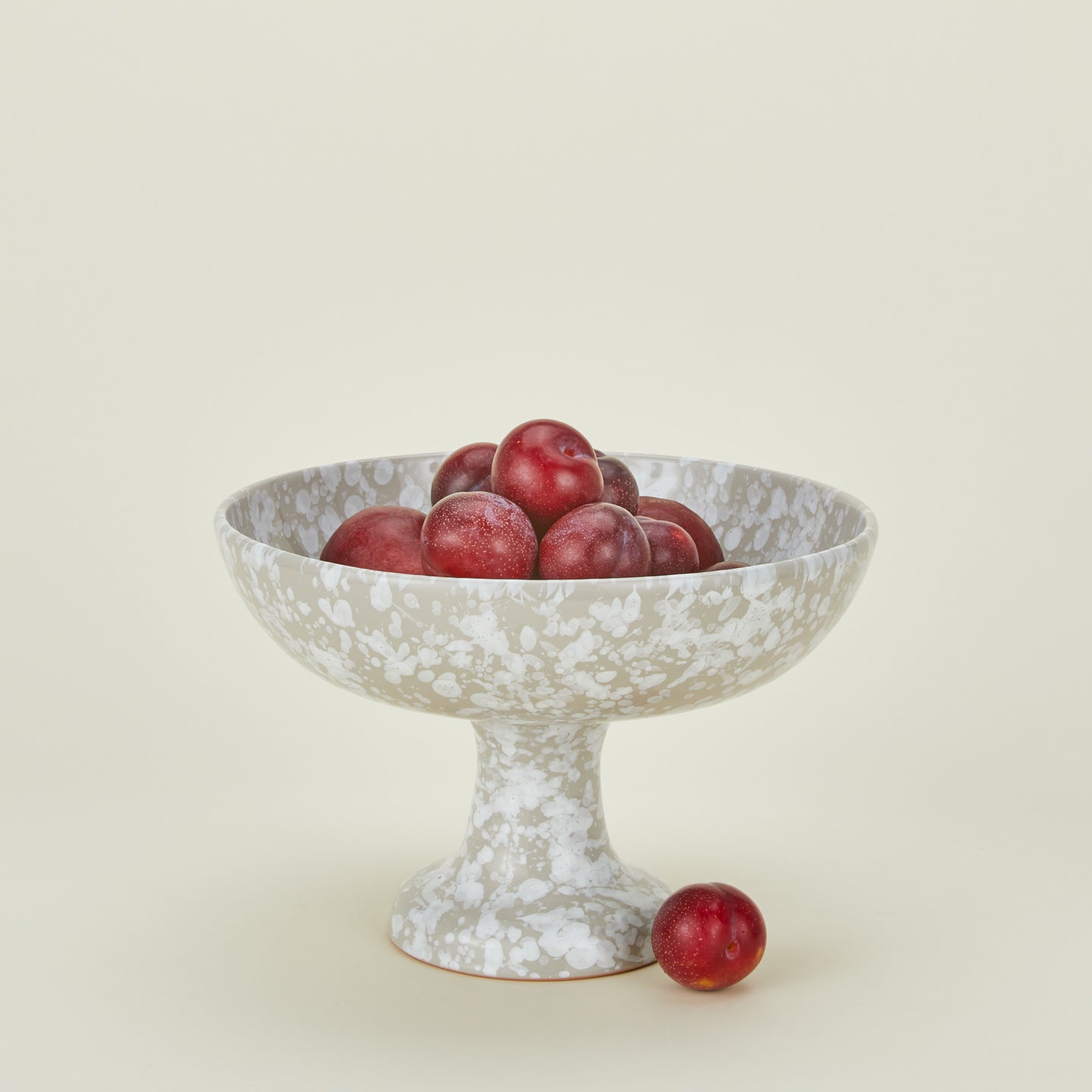 Splatterware footed bowl in grey and white with plums
