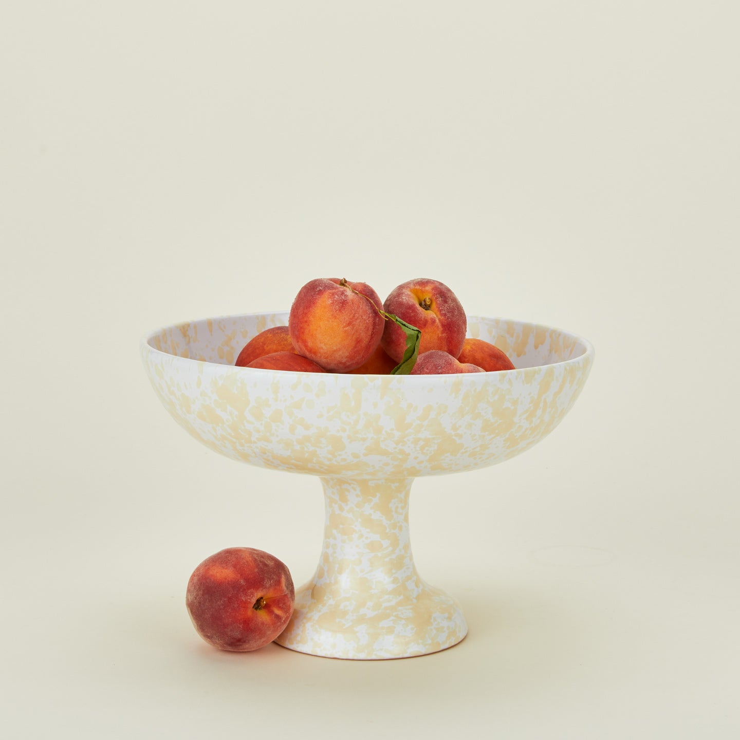 Splatterware footed bowl in white and ivory with peaches