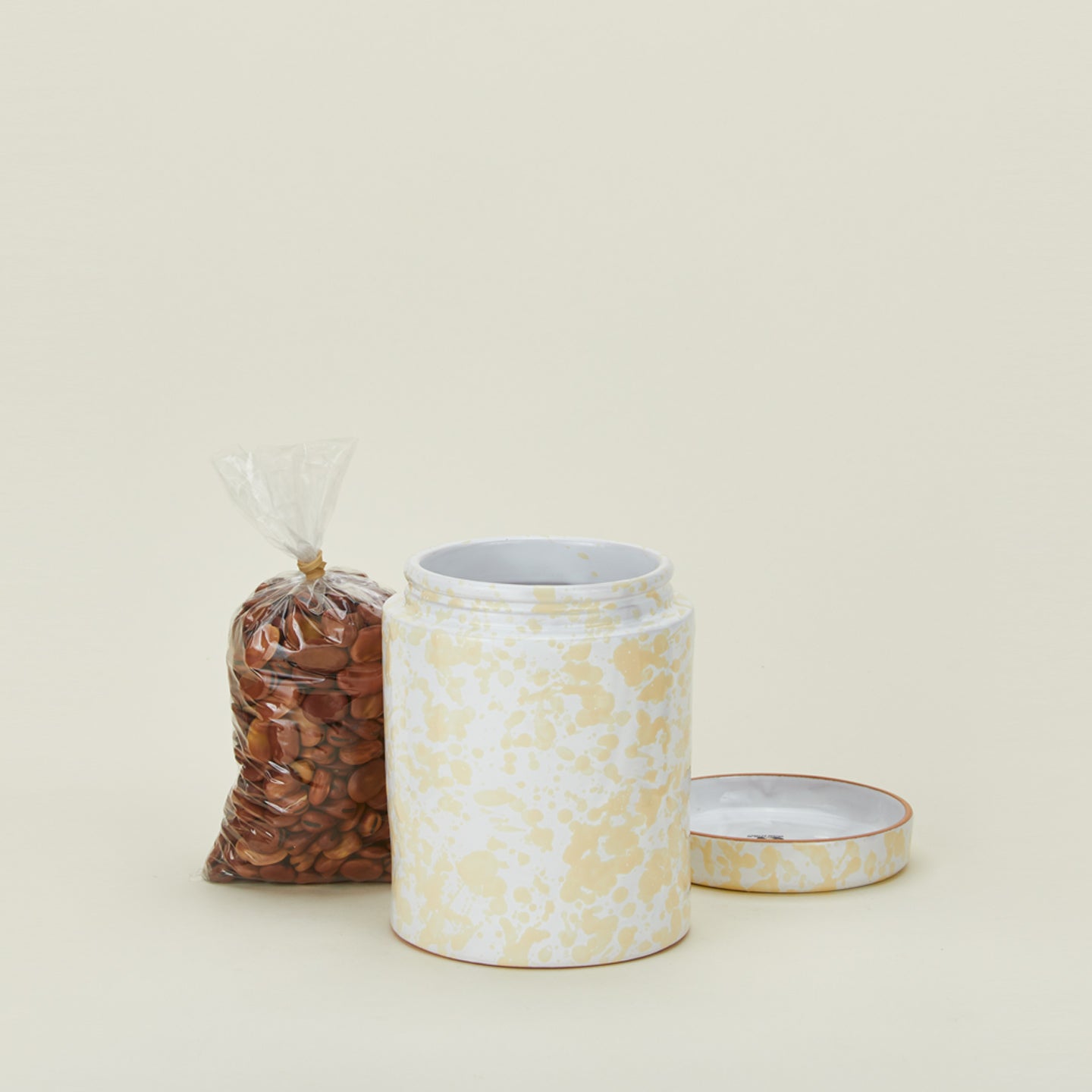 Medium splatterware canister in white and ivory with nuts