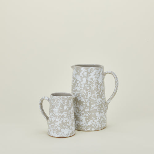 Large and small splatterware pitchers in grey and white