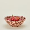 Splatterware serving bowl in blush and terracotta with apples