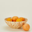 Splatterware serving bowl in ivory and bronze with oranges