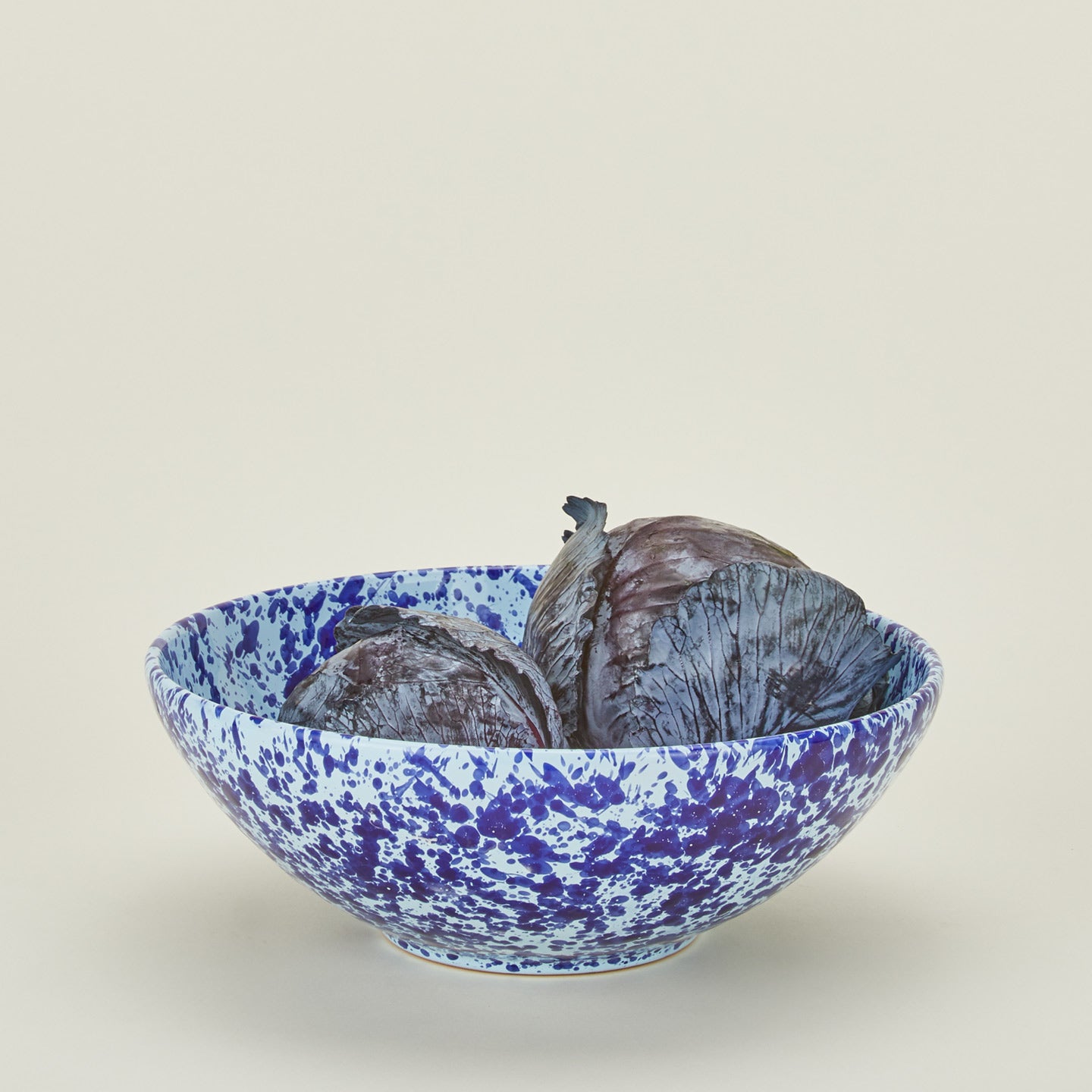 Splatterware serving bowl in sky and cobalt with lettuce