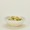 Splatterware serving bowl in white and ivory with tomatillos