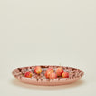 Splatterware serving platter in blush and terracotta with apples