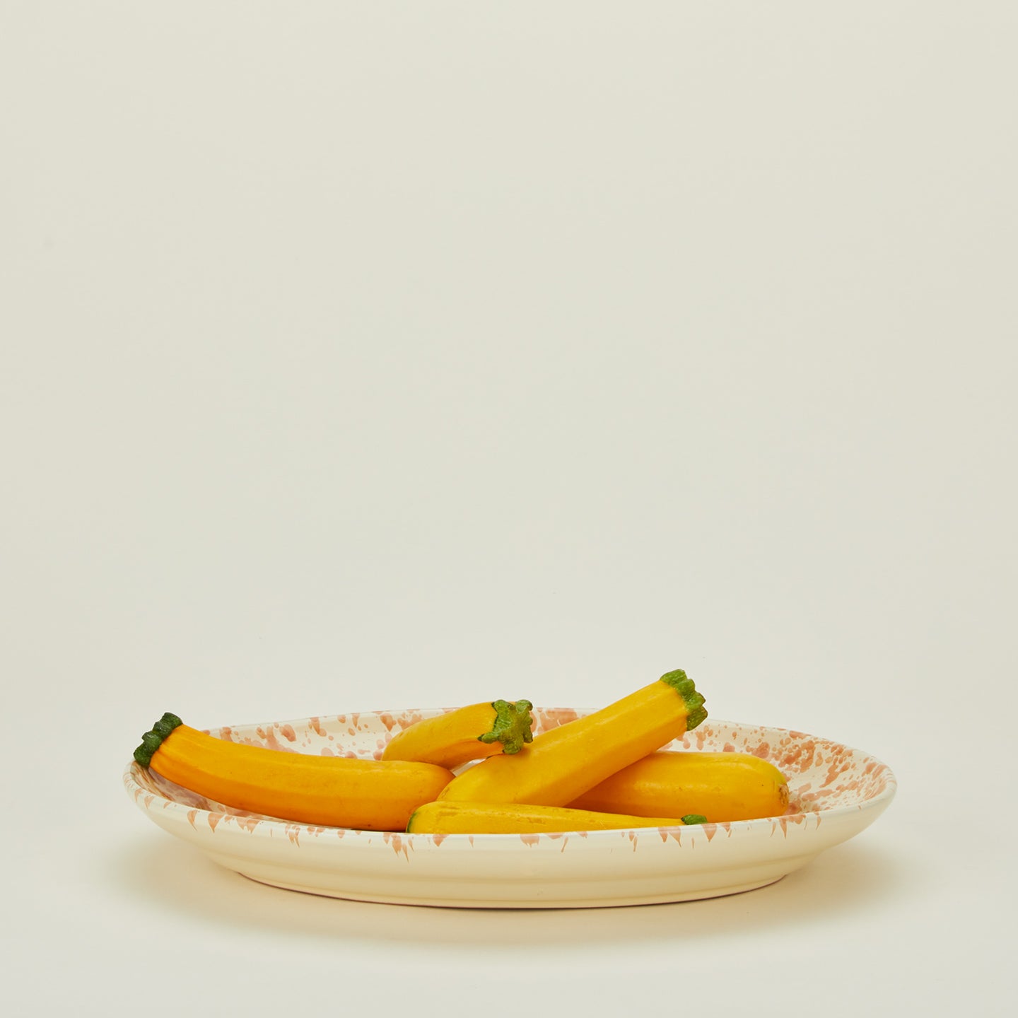 Splatterware serving platter in ivory and bronze with squash