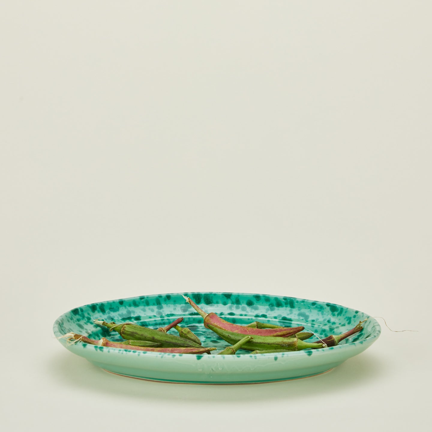 Splatterware serving platter in sage and green with chiles