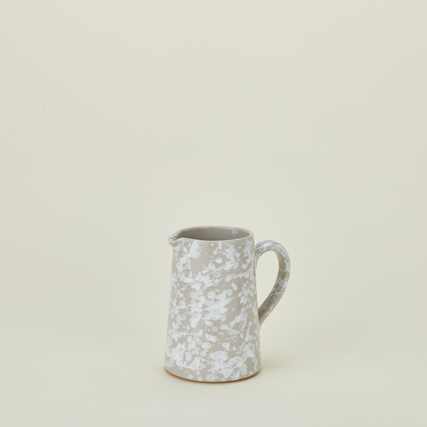 Small splatterware pitcher in grey and white