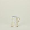 Small splatterware pitcher in white and ivory
