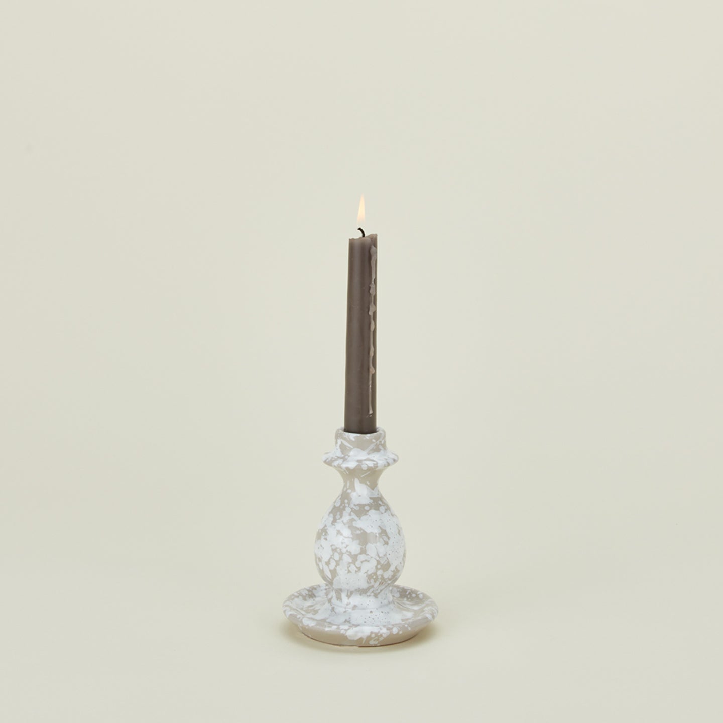 Small splatterware candlestick in white and grey with candle