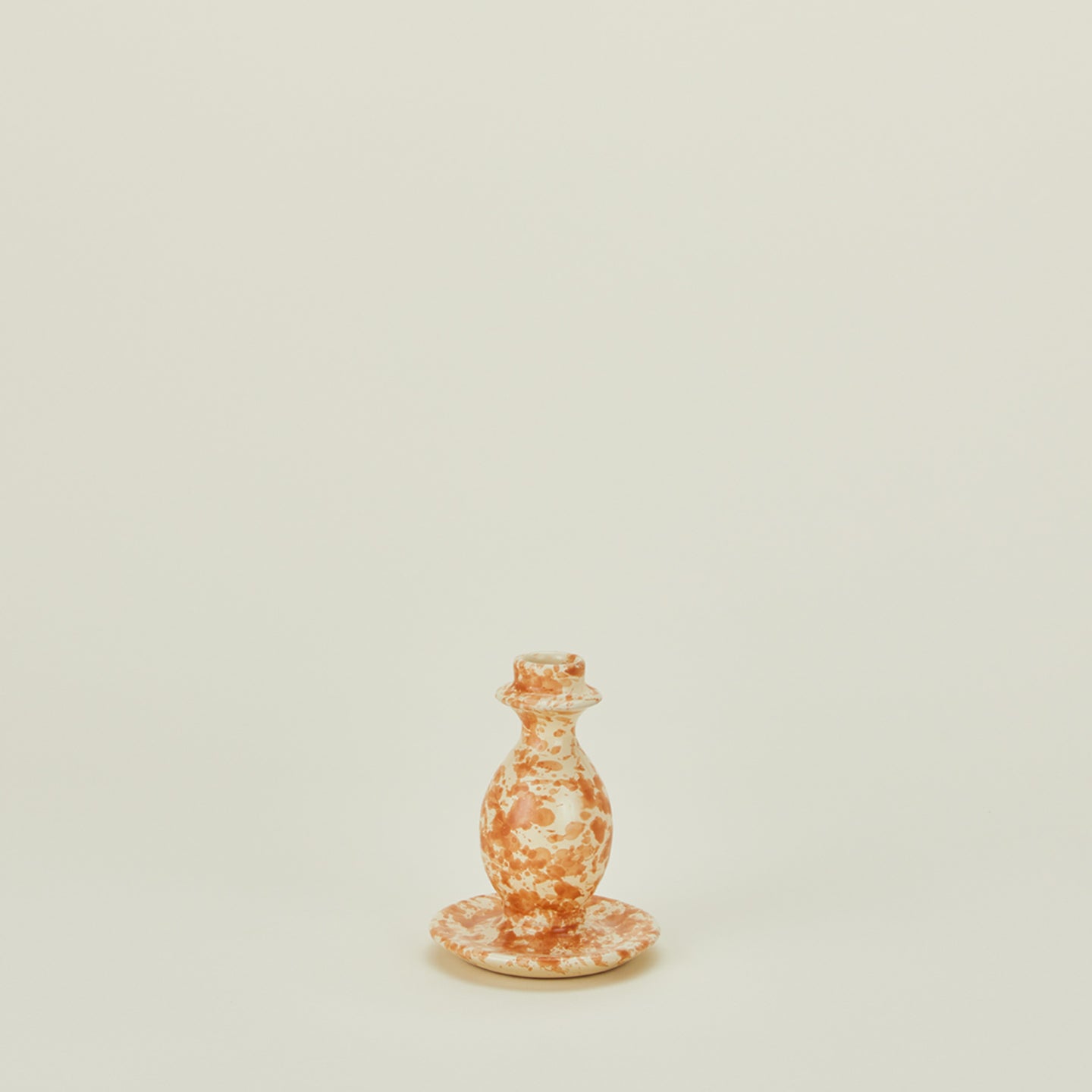 Small splatterware candlestick holder in ivory and bronze