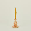 Small splatterware candlestick holder in ivory and bronze with candle