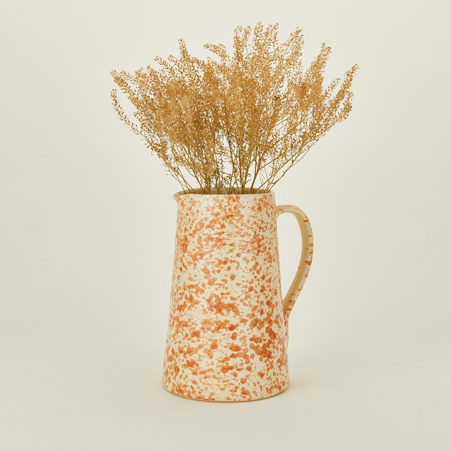 Large splatterware pitcher in ivory and bronze with florals