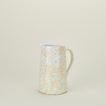 Large splatterware pitcher in white and ivory