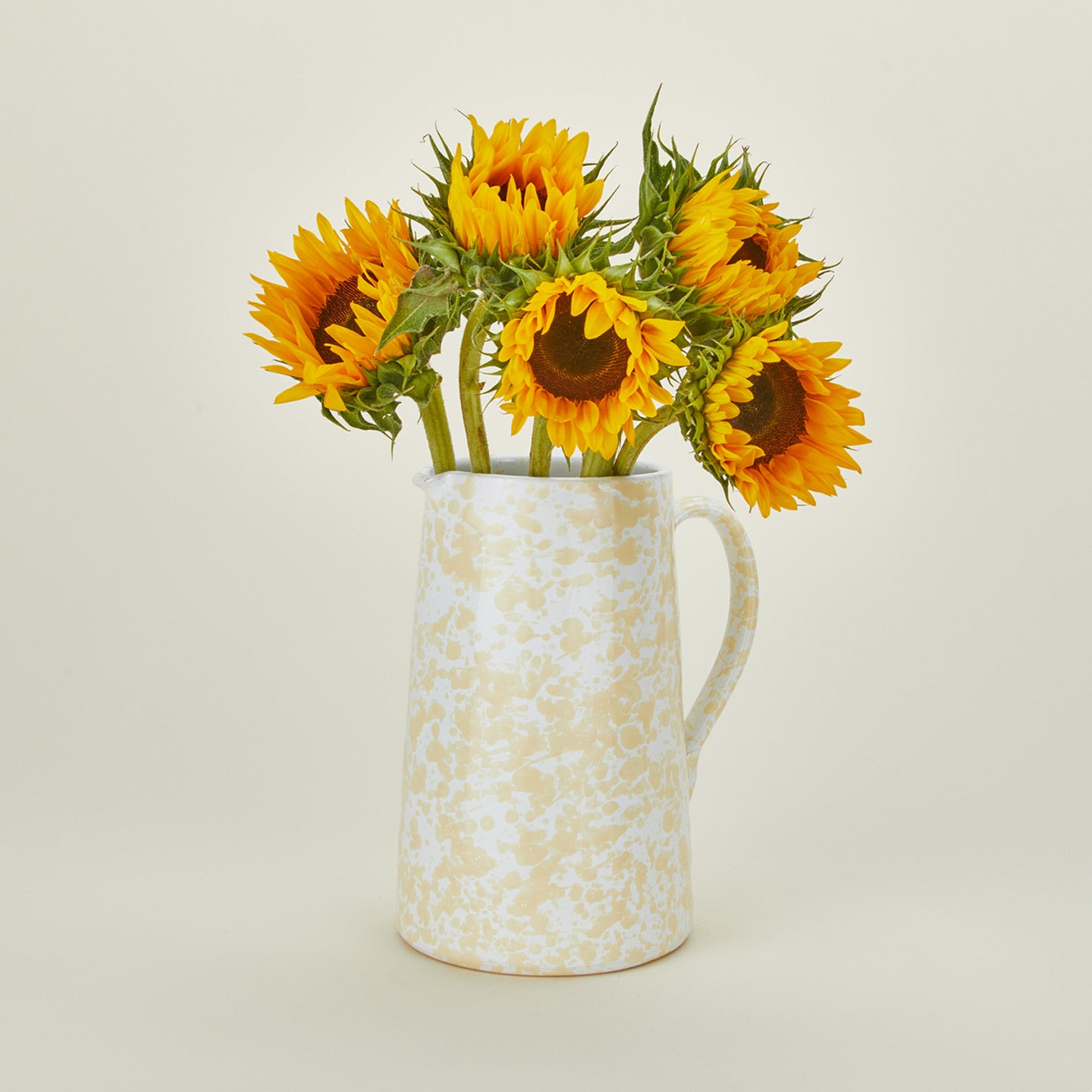 Large splatterware pitcher in white and ivory with sunflowers
