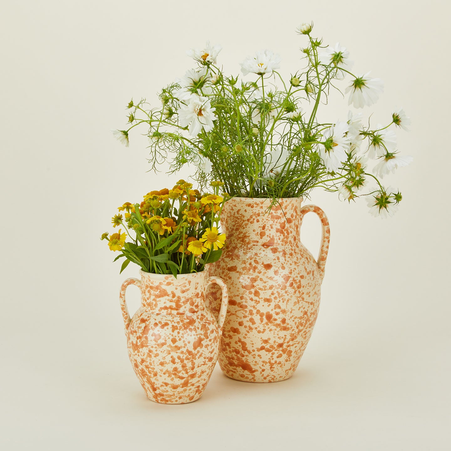Large and small splatterware vases in ivory and bronze with florals