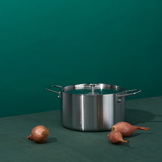 Stainless steel pan with shallots. 