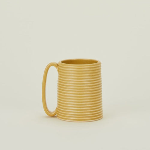 A marigold tall ribbed mug.