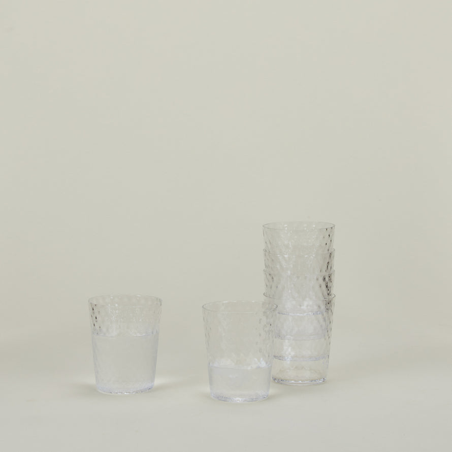 Set of 6 Veneziano Tumblers in Clear, stacked, with water.