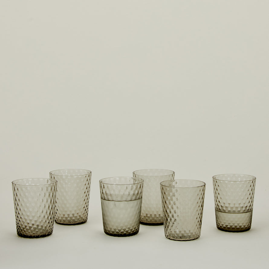 Set of 6 Veneziano Tumblers in Grey, with water.