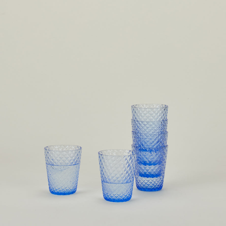 Set of 6 Veneziano Tumblers in Light Blue, stacked, with water.