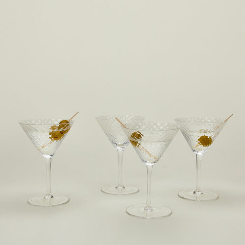 Four Veneziano martini glasses with martinis.
