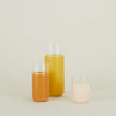 Simple Glass Pitcher and two Simple Glasses filled with orange liquids.