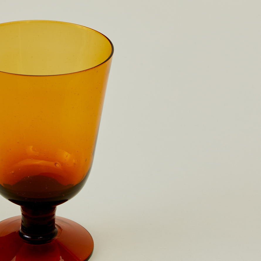 Close up of Stemmed Wine Glass in Amber.