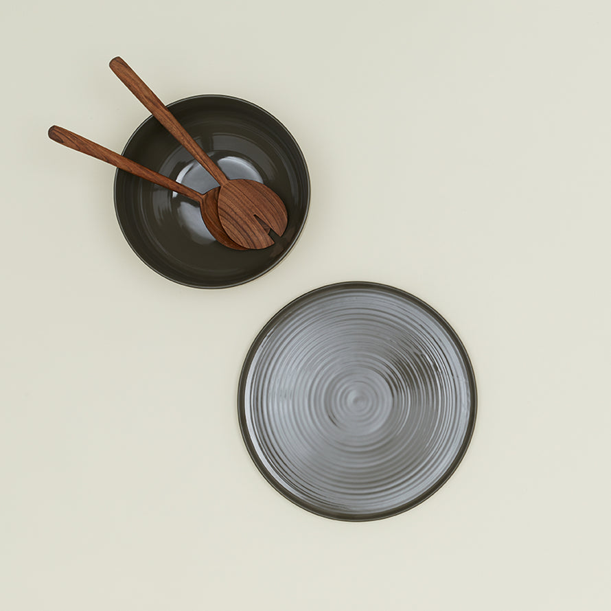 Essential Serving Bowl and Serving Platter in Olive, with wood serving utensils.