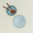 Essential Serving Platter and Serving Platter in Sky, with wood serving utensils.